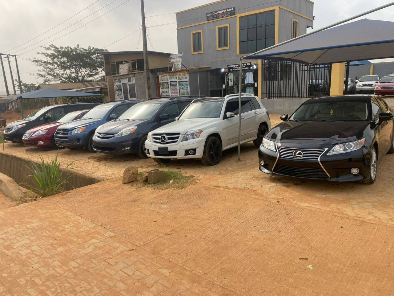 Vehicles displayed outside Olasheu Ara Autos in Ikorodu